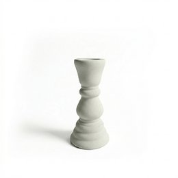 White ceramic candle holder with a tall, cylindrical shape and a tapered base.
