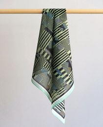 Silk-cotton blend scarf in a geometric pattern of green and blue stripes.