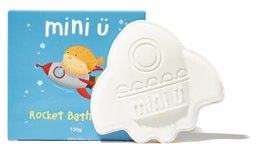 White rocket-shaped bath bomb, playful space theme design, children's bath toy with embossed details.