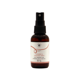 Intimate hygiene and cleaning spray in a small brown bottle with a black spray nozzle.