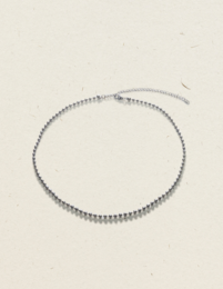 Silver charm bracelet with delicate chain and sparkling accents.