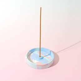 Artisanal incense holder made in France, available in multicolor, rose, green, and blue variants. Features a round, ceramic base with a central incense stick holder.