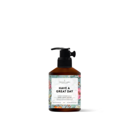 Hand and body lotion with a floral scent, featuring a pump dispenser for easy application. Moisturizes skin with natural ingredients.