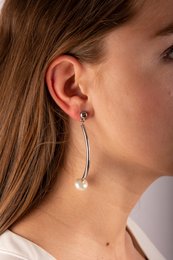 Elegant silver-toned stud earrings with a simple, minimalist design featuring two spherical beads.