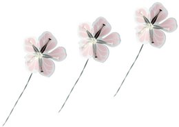 Small, delicate flowers in shades of purple, pink, and silver, arranged in a decorative wreath.