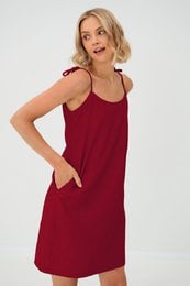 Sleeveless linen slip dress with pockets, available in cerise, lavender blue, and beige colors.
