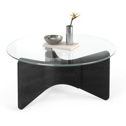 Round glass coffee table with black wooden bow-tie base, modern minimalist design, clear top surface.