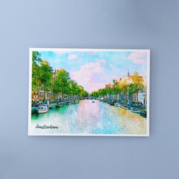 A6 postcard with envelope featuring a colorful painting of a canal in Amsterdam, Netherlands. The image shows a scenic waterway lined with boats, trees, and buildings in a vibrant, impressionistic style.