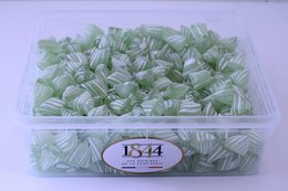 Green apple-flavored hard candies in a 1kg box, suitable for a variety of uses.