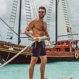  Dark blue swimming trunks with a relaxed, casual style. Made of lightweight, quick-drying fabric for comfortable wear at the beach or pool. Features an elastic waistband and drawstring for a secure fit.