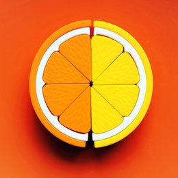 Wooden citrus fruit puzzle toy, orange and yellow lemon slices, round segmented shape, sensory learning toy.