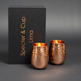 A set of 2 hammered copper cocktail cups, each with a capacity of 470 ml. The cups have a unique, textured surface that adds visual interest and a premium feel to the product.
