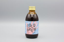 Cold brew coffee from Ethiopia, dark brown liquid in glass bottle with white label.