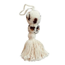 Handcrafted pom pom bag charm in a crocheted leopard print design, made with wool and cotton in Nepal.