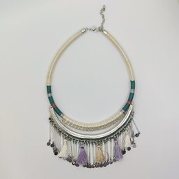 Elegant necklace with beige cord, teal and purple beads, and dangling tassels. Stylish boho-chic accessory.