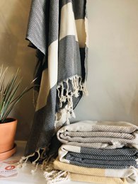 Soft, absorbent Turkish towel and blanket made of 100% cotton. Available in a variety of colors including black, mustard, beige, petrol, blue, cream, soft pink, and bubblegum. Measures 39" x 70" / 100 x 180cm.
