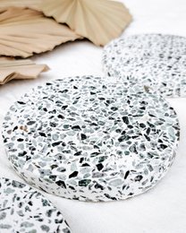 "Round white speckled coasters with black flecks, terrazzo style, modern minimalist design, set of coasters"
