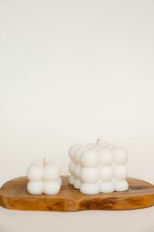 Cube-shaped pillar candle with a bubble-like texture, available in classic, baby, and set variants.
