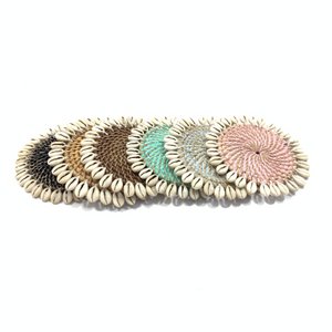 Rattan coaster with cowrie shells