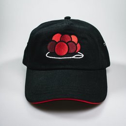 Black baseball cap with red paw print design, unisex style.