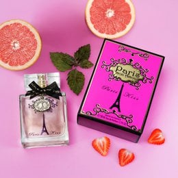 A floral, feminine perfume in a pink bottle with an Eiffel Tower design, evoking the romantic charm of Paris.