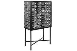 A black metal bottle holder with a grid of square cutouts in various geometric shapes and patterns.