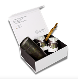 A collection box containing Bahama mama skin and hair beauty superfoods. The box includes a cylindrical container and two smaller containers, along with a wooden utensil.