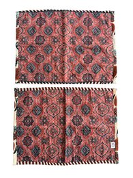 Quilted sari placemat set, red coral fabric with black floral damask pattern, traditional textile design.