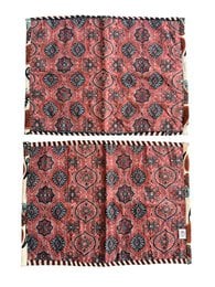 Quilted sari placemat set, red coral fabric with black floral damask pattern, traditional textile design.