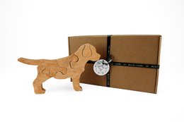 Wooden puzzle puppy toy, made of natural materials, with a simple, playful design suitable for young children.
