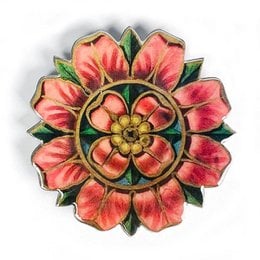 Decorative brooch with a vibrant floral design in shades of pink and yellow. The brooch features a round, layered flower shape with petals and a central stamen. The brooch has a metallic finish and the brand name "VOGLIO BENE" is visible on the surface.