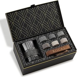 The Connoisseur's Set - Reserve Whiskey Glass Edition includes a set of eco-crystal whiskey stones and a premium whiskey glass. The stones are designed to chill whiskey without diluting the flavor, while the glass features a classic diamond pattern design.