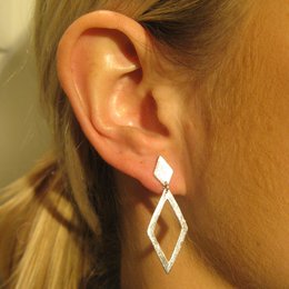 Silver diamond-shaped earrings with a modern, minimalist design.