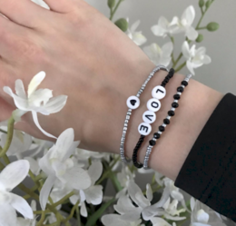 Silver and black beaded bracelets with love charm