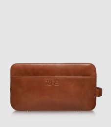 Cognac-colored toiletry bag with a sleek, rectangular design. Made of durable, high-quality material. Ideal for storing and organizing personal care items during travel.