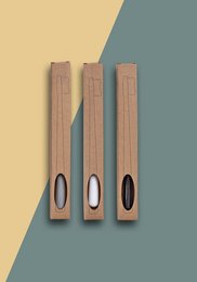 Rectangular wooden toothbrush boxes in neutral colors of black, gray, and white. The boxes feature minimal design with oval cutouts and text labels.