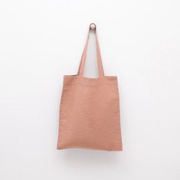 A beige linen tote bag with a simple, minimalist design. The bag has a rectangular shape and a single strap for carrying.
