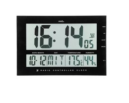 A large digital clock with a black frame and a clear LCD display. The clock shows the current time, date, and temperature.