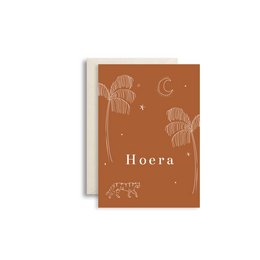 Greeting card with rust-colored background and white floral illustrations. The card is titled "Hoera" which means "Hurray" in Dutch.