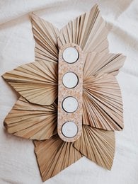 "Flower-shaped tealight holder, natural wood petals, vertical four-candle design, beige tan color"