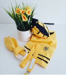 Yellow and black baby rattle set with pacifier, teething ring, and storage pouch.