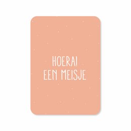 Greeting card with text "Hoera! Een meisje" (Hooray! A girl) in white text on a peach-colored background.