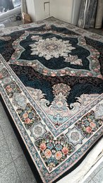 Large dark blue area rug with intricate floral and geometric patterns, suitable for living rooms or bedrooms.