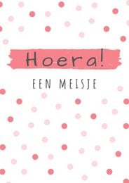 A pink and white polka dot card with the text "Hoera! Een meisje" (Hooray! A girl) in a handwritten style font.