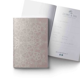 A5 sized notebook with a bohemian mandala pattern cover in a light pink color.