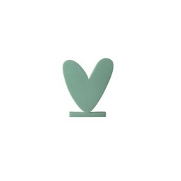 Green acrylic heart-shaped card with text "Spread a little love" on a wooden shelf.