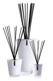 Lavender, amber, and vetiver reed diffuser set with sleek white ceramic containers and black reeds.
