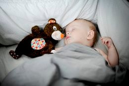 Soft, plush comforter in a neutral color, perfect for cuddling and relaxing. Includes a cozy stuffed animal companion.