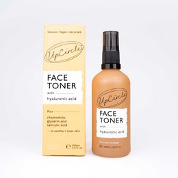 Face toner with hyaluronic acid, clear glass bottle, transparent liquid, skin care product.