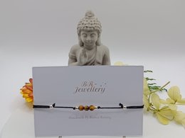 Delicate tiger eye gemstone bracelet, available in various metal finishes including silver, gold, and rose gold. Features a natural tiger eye stone charm.